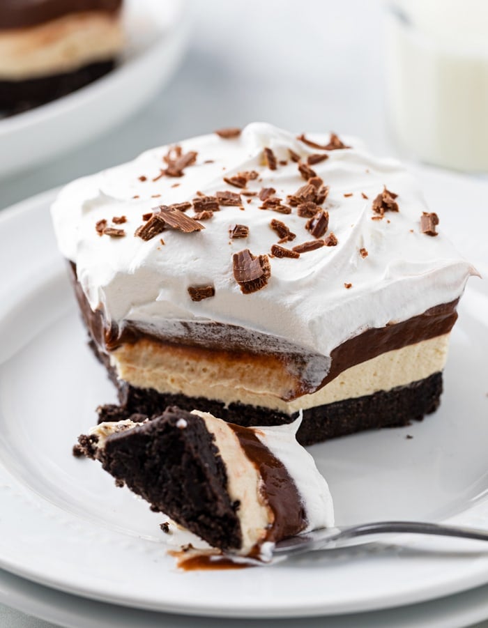 A white plate with Peanut Butter Delight on top with a fork.