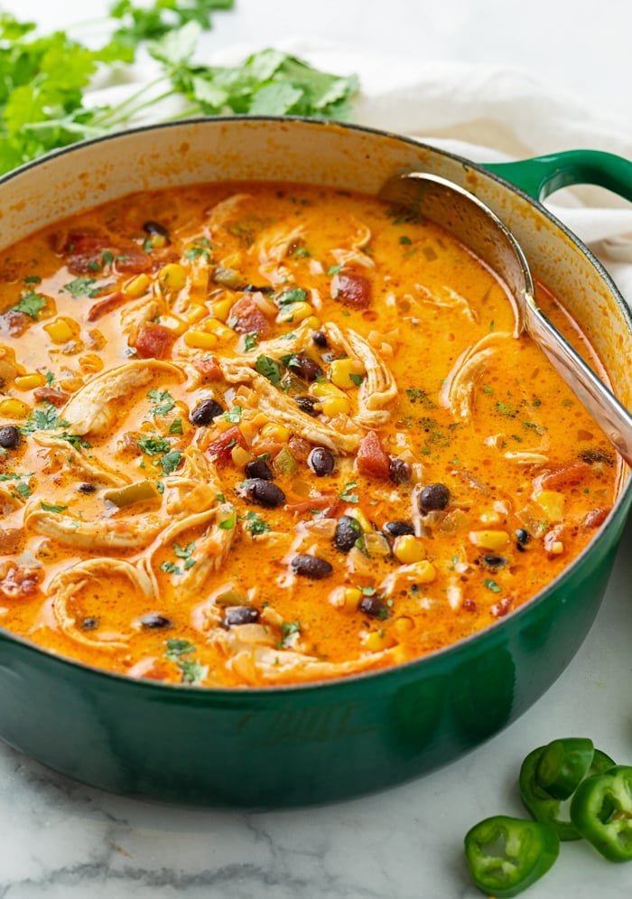 Chicken Enchilada Soup in a green Dutch oven.