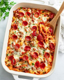 Pizza Pasta in a white casserole dish with pepperoni on top.