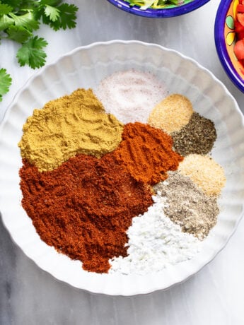 Taco seasonings in a white bowl before being combined together.