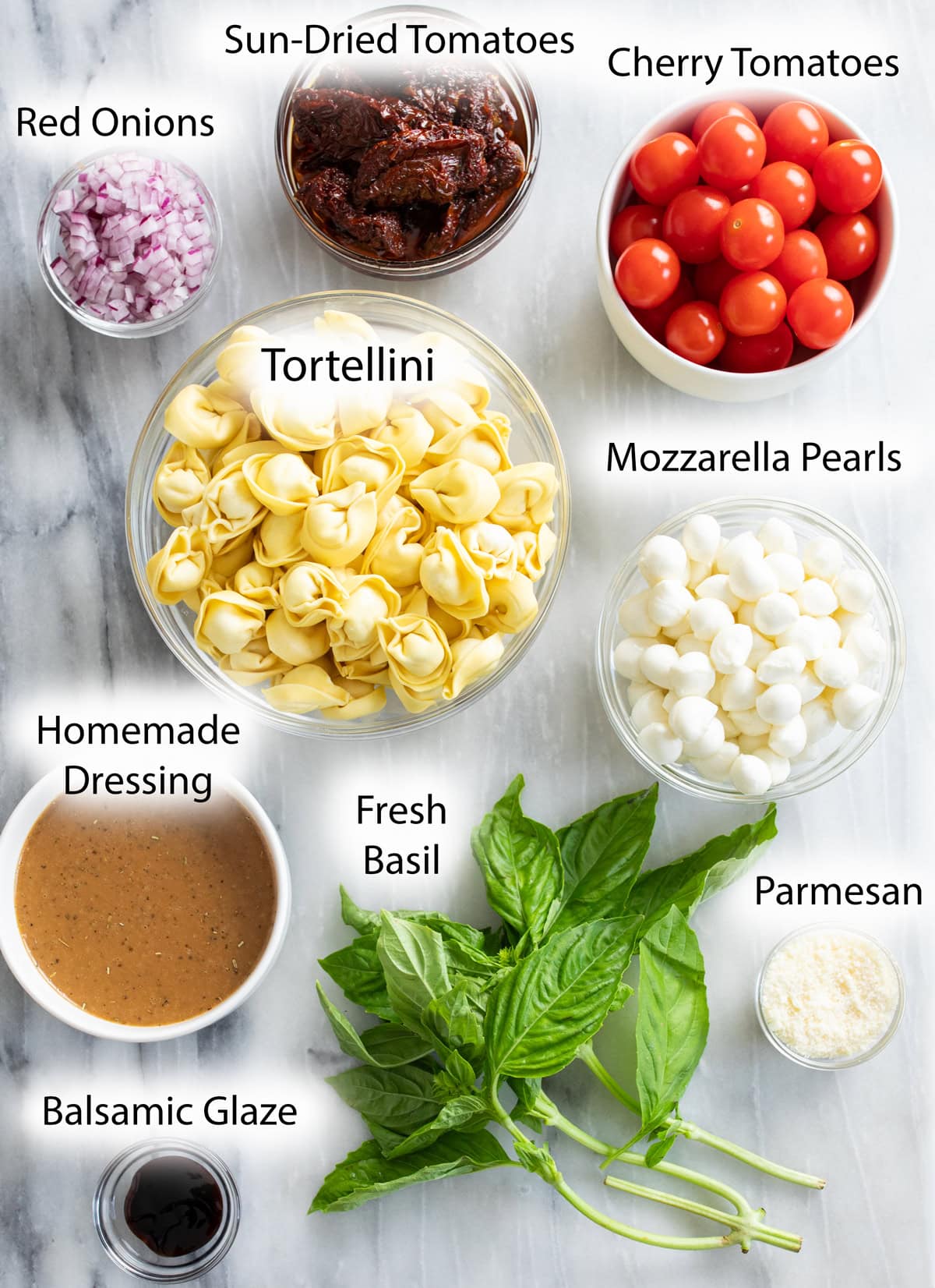 Overhead view of ingredients needed to make Caprese Pasta Salad.